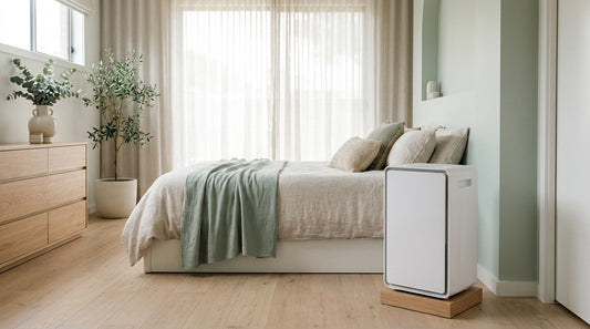 A sleek modern white dehumidifier in a bright contemporary Australian bedroom, soft natural light, calm and dry, sage-mi