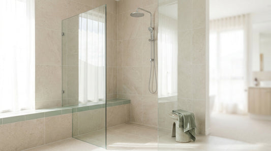 A spotless modern Australian walk-in shower, pale tiles and a clear glass screen, bright natural light, clean grout and 