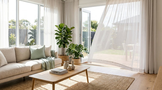 A bright airy contemporary Australian living room with open windows and a breeze in the sheer curtains, indoor plants, s