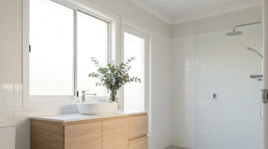 A clean, bright contemporary Australian bathroom with white tiles in morning light